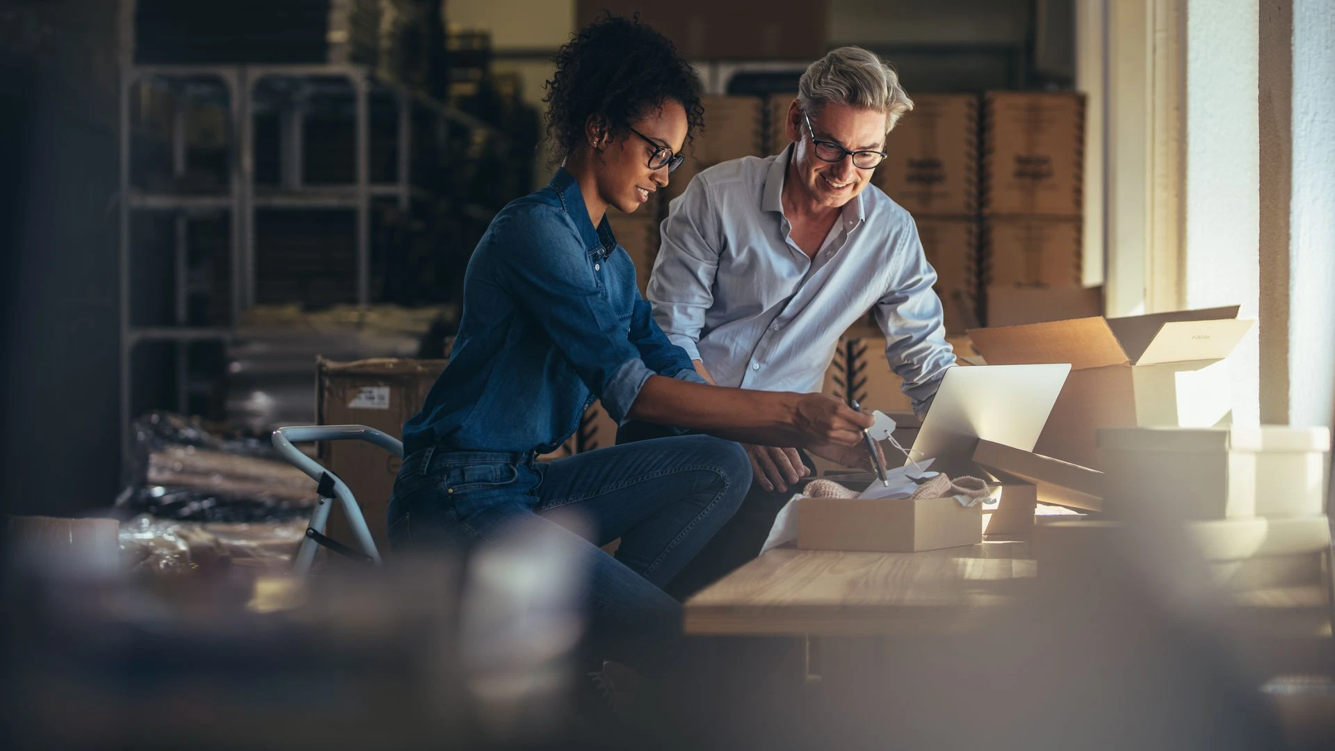 Small business team packing products and preparing e-commerce orders in a warehouse.
