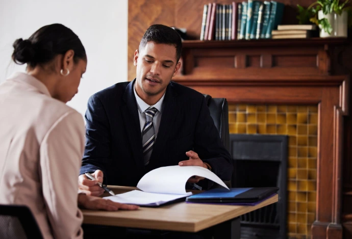 Attorney reviewing documents with a client during a legal consultation.
