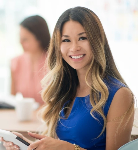 Woman holding a clipboard smiling